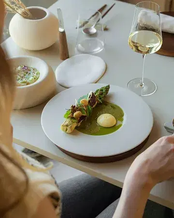 We present the first act of our asparagus experience 🌿 Triple-A green asparagus from @stephanelonglune, roasted and glazed with lovage liqueur, pumpkin seed praline, tangy egg yolk cream, fermented asparagus coulis, and nasturtium flowers. A true celebration of spring ✨