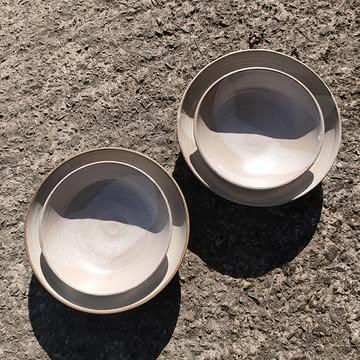 Deep plates in two sizes and 5 glaze combinations.
These plates are incredibly versatile, perfect for almost any meal.
After refining the design over the years and making hundreds for restaurants and private commissions, I've decided to offer a PRE-ORDER sale.
.
This way, you can choose your favorite size and color combinations, and I can create only what's needed, reducing waste.
.
Global situations will again affect production costs - no complaints, just a reality.
I'm fortunate to look at the sky with birds and clouds instead of darkness.
.
The last glaze firing showed me that even with precision, unpredictability is part of the process.
I've recently experimented with unwashed wood ash, which affects the glaze's behavior over time.
Something to consider for a pre-order: washing ashes and stop changing my processes! 🙈😬
.
In the last pictures you see wonderful examples of CRAWLING which here is due to the thickness application & the switch to unwashed wood ash.
.
I think it's important to share the flaws, it's part of the process when you keep experimenting.
.
All the details for the pre-orders will be sent by NEWSLETTER 📨 link to subscribe in my bio.