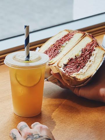 The Arnold Palmer Is Back! 

Named after golf legend Arnold Palmer, the Arnold Palmer has been a favorite for generations. This classic drink combines refreshing iced tea with crisp lemonade, creating the perfect balance of sweet, tart, and smooth flavors.

And if you’re looking for the ultimate pairing, enjoy it with our Reuben Pastrami Sandwich—stacked high with flavorful pastrami, provolone cheese, sauerkraut, and dressing on grilled brioche bread. The bright citrus notes of the Arnold Palmer cut through the richness of the sandwich, making every bite even better.

Whether you’re stopping in for lunch or grabbing a quick bite, this classic combo is hard to beat.